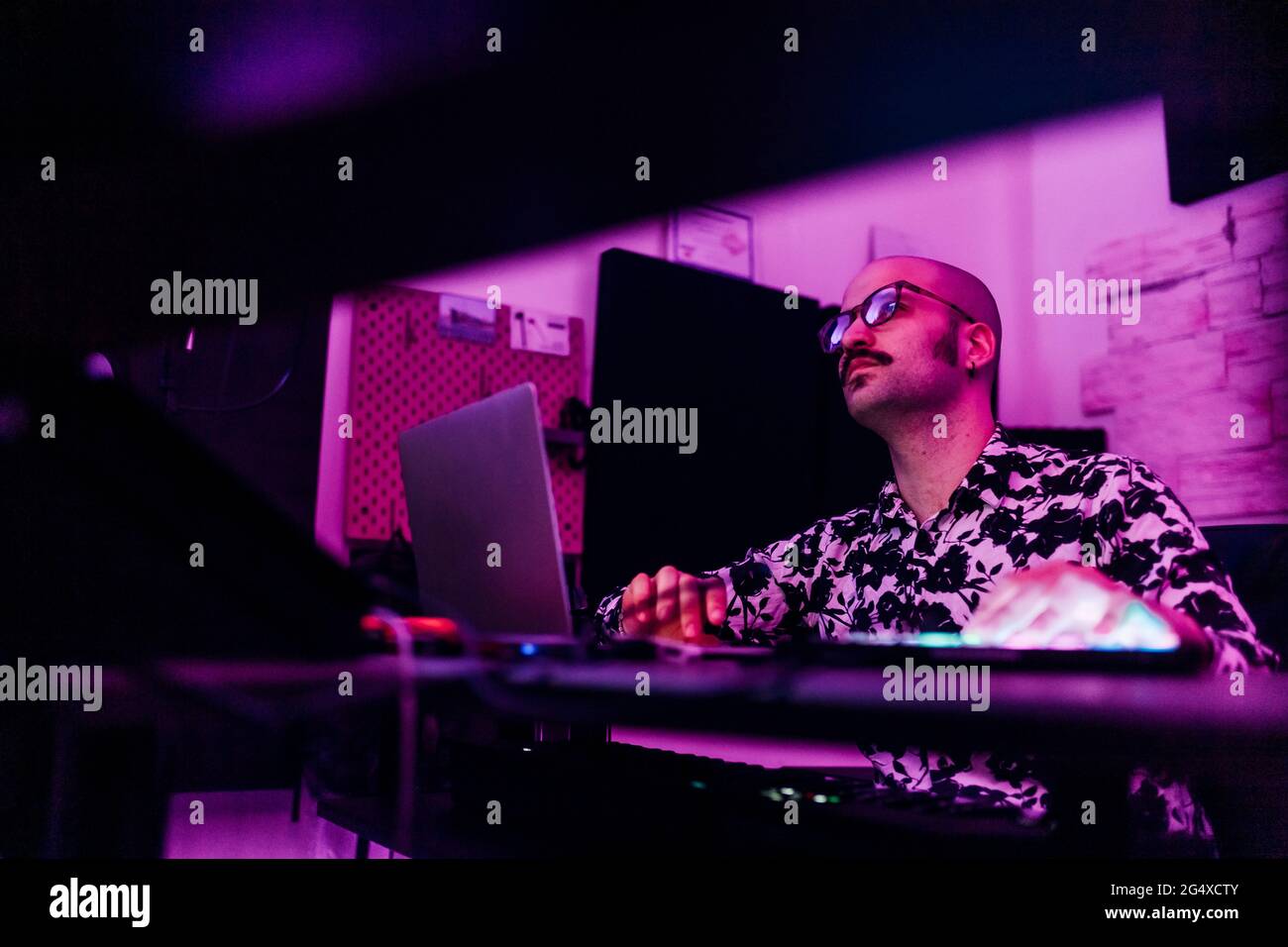 Male composer wearing eyeglasses composing music at studio Stock Photo