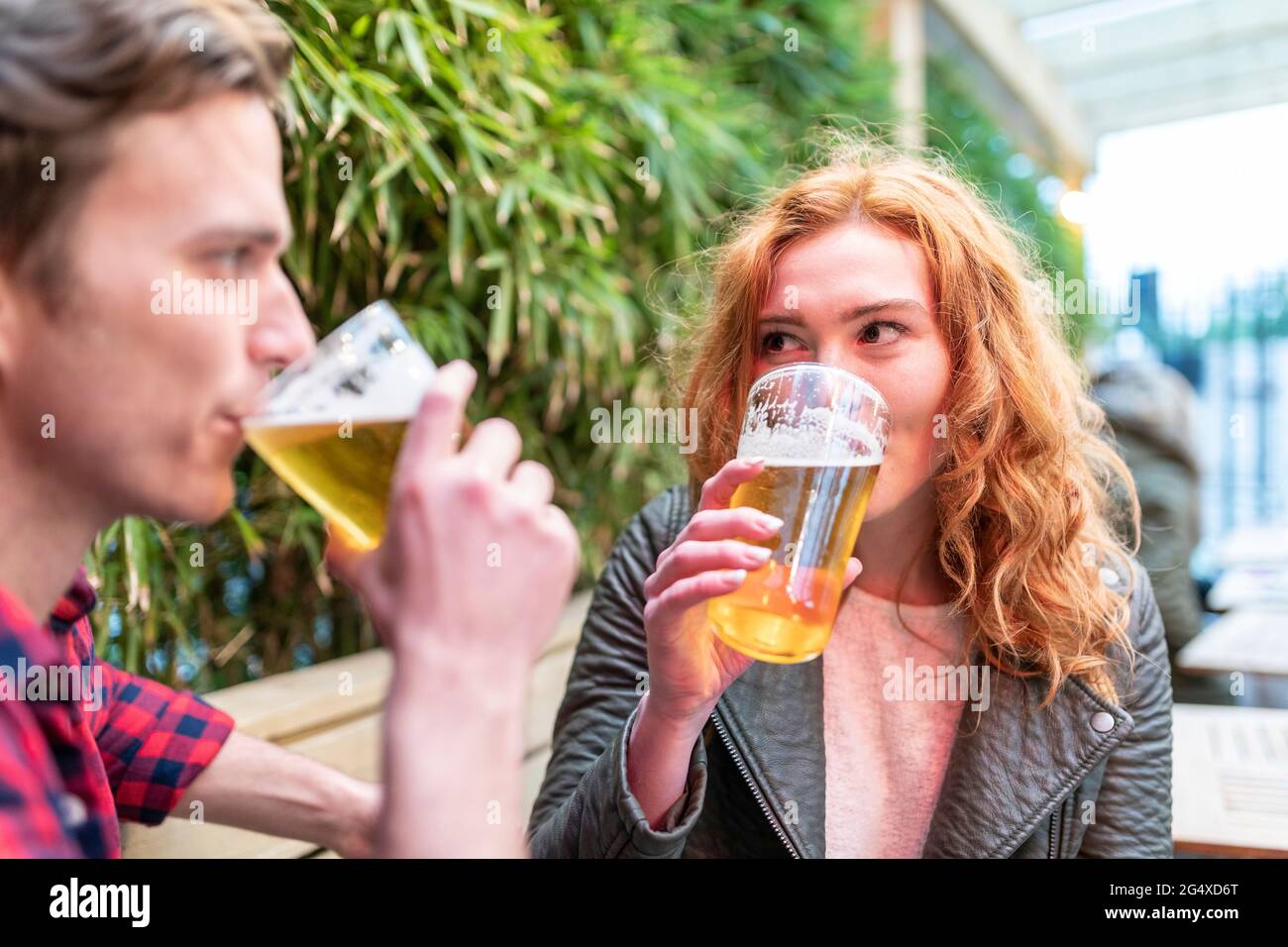 Couple drinking beer at pub Stock Photo
