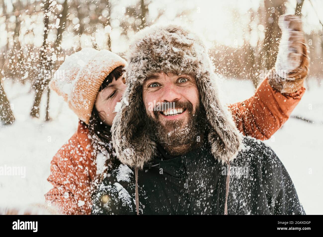 Couple having fun in forest during winter Stock Photo