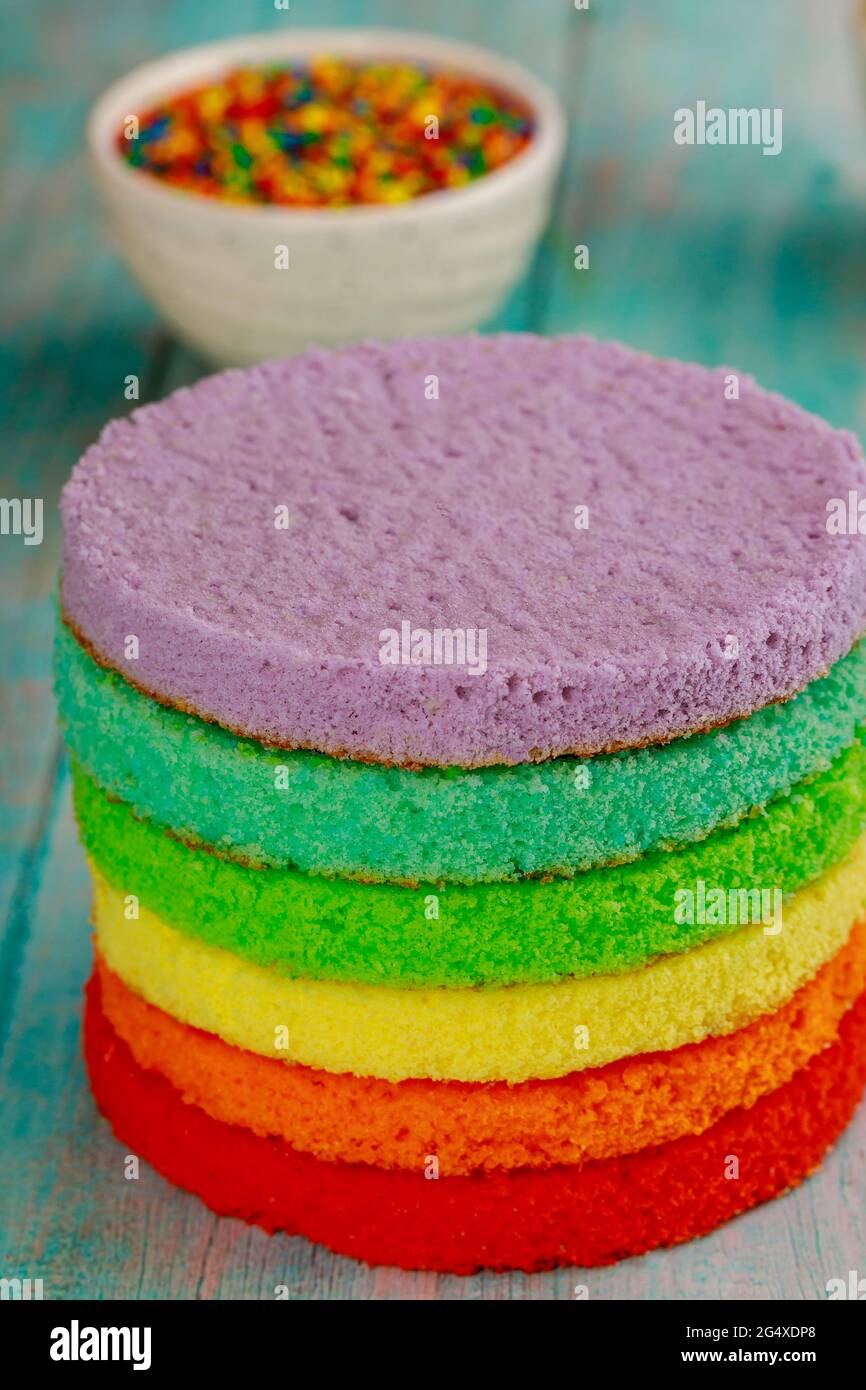 Rainbow birthday sponge cake with color sprinkles Stock Photo - Alamy