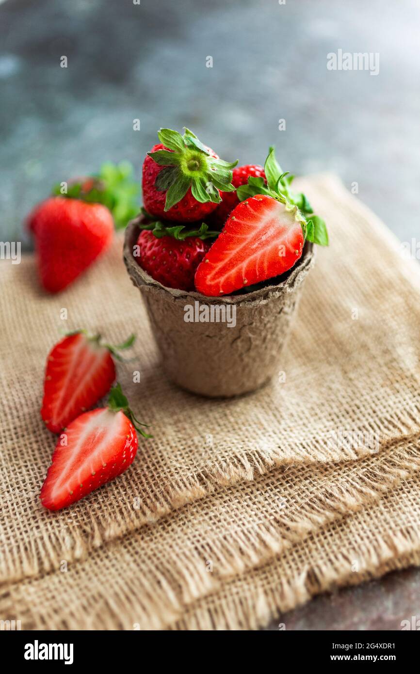Cup of fresh ripe strawberries lying on place mat Stock Photo