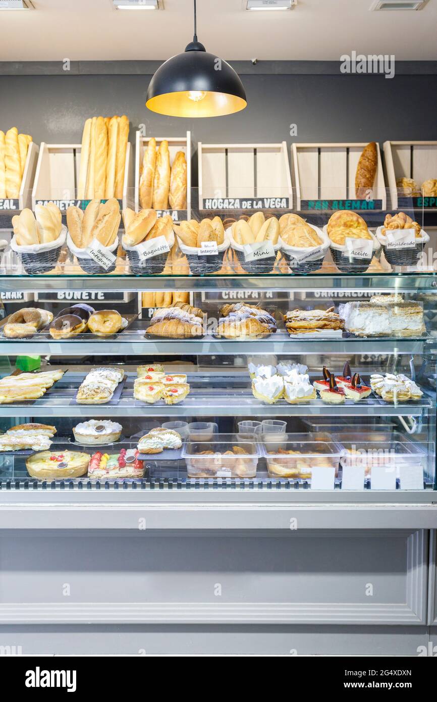 Various pastry items in display cabinet at bakery Stock Photo