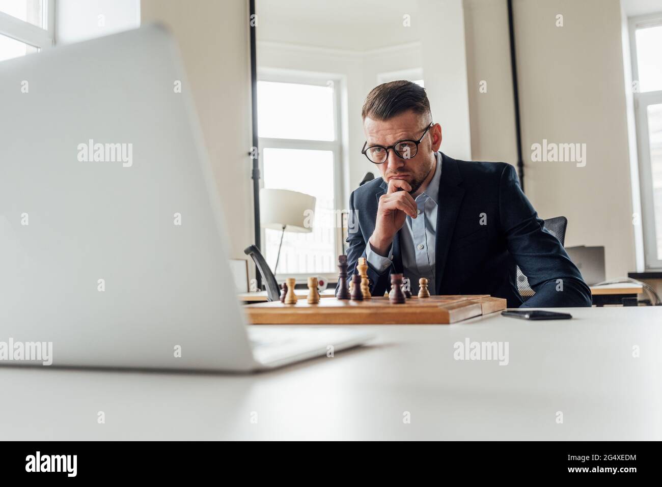 Caucasian man playing chess computer hi-res stock photography and