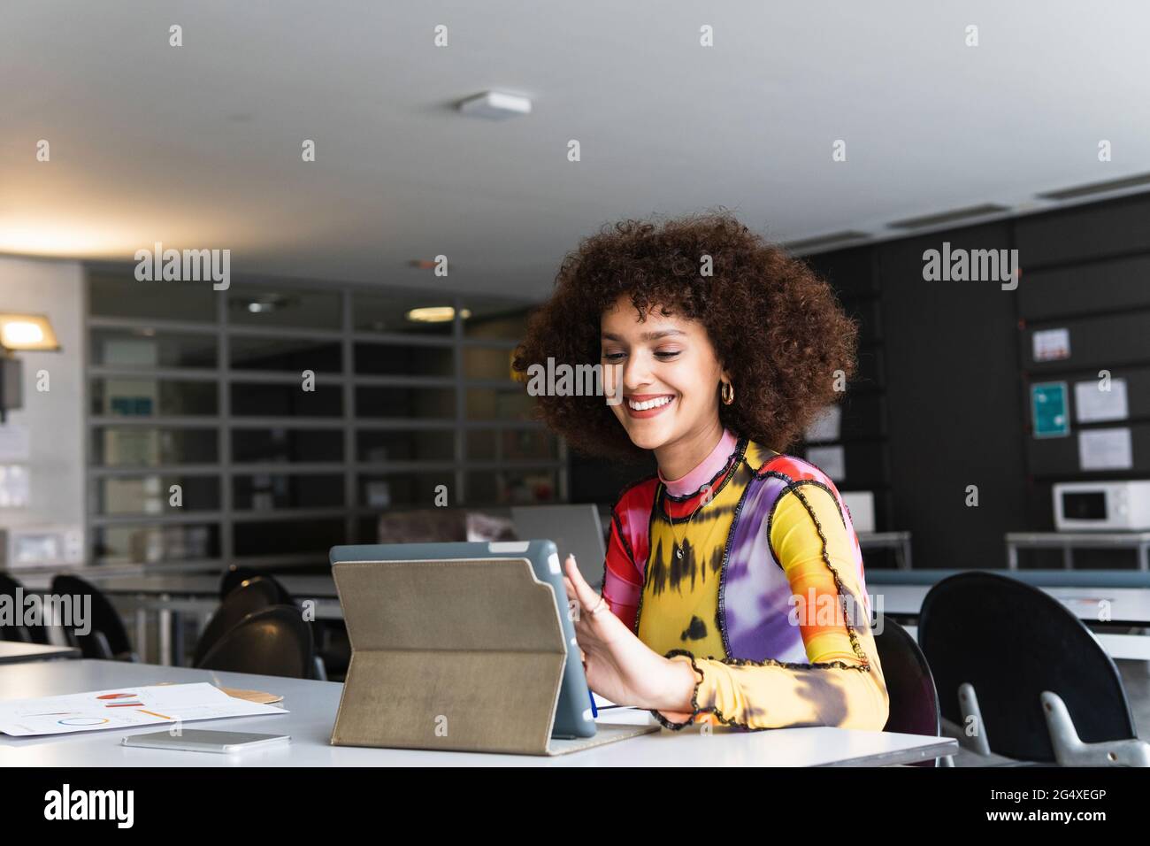 Smiling university student using digital tablet in library Stock Photo