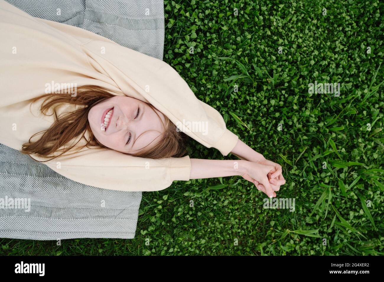 Happy girl lying on grass hi-res stock photography and images - Alamy