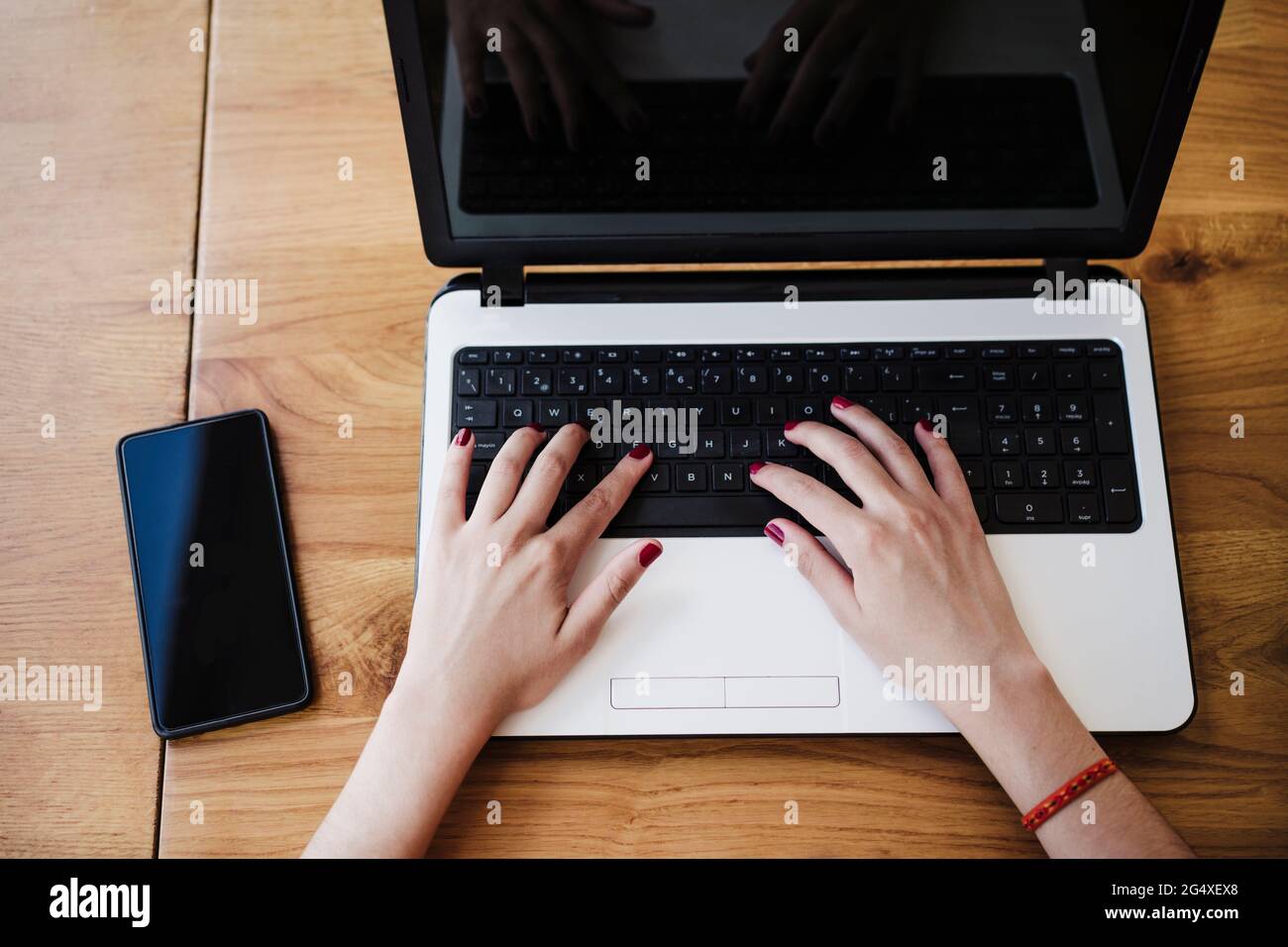 Female freelance worker using laptop at cafe Stock Photo