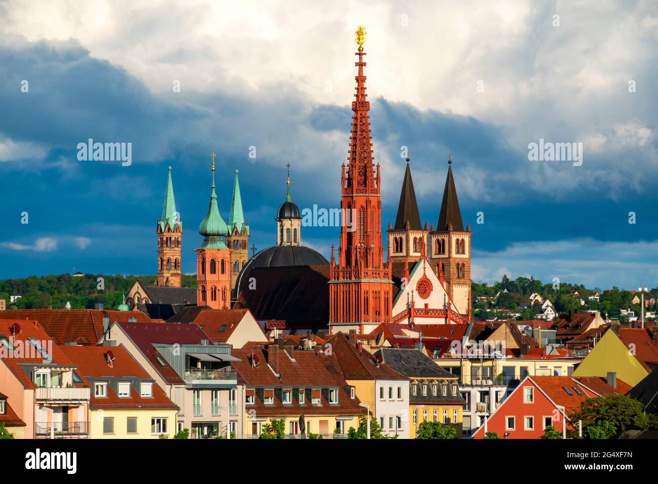 Germany, Bavaria, Wurzburg, Clouds over Marienkapelle and surrounding houses Stock Photo