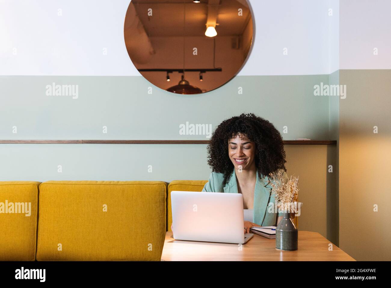 Female freelance worker using laptop in restaurant Stock Photo