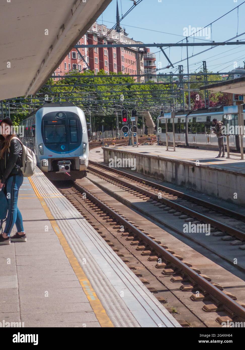 San Sebastian, Spain - May 13, 2019: incoming train and waiting passengers  at Amara train station Stock Photo