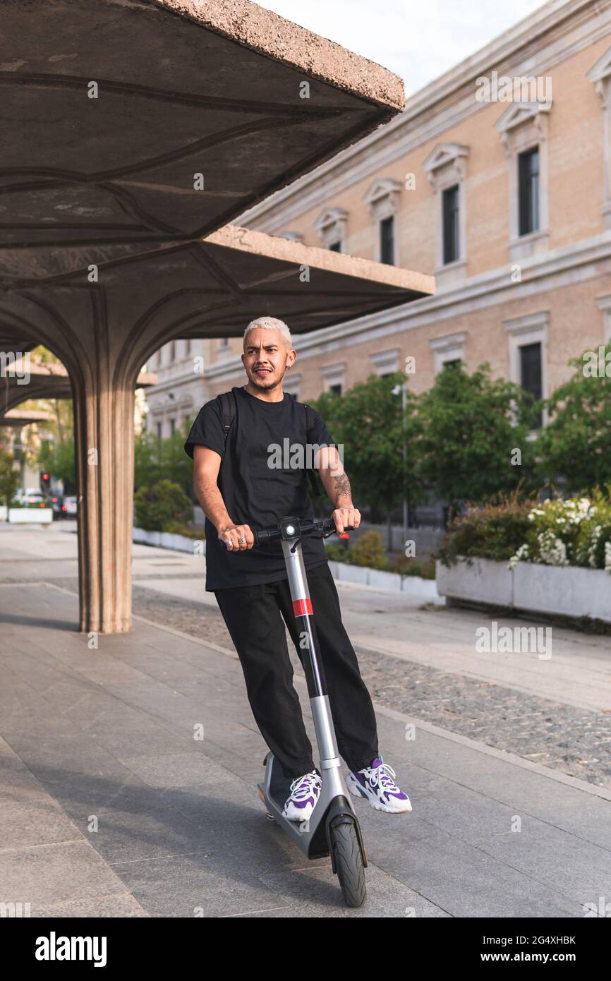 Male on electric scooter riding hi-res stock photography and images - Alamy