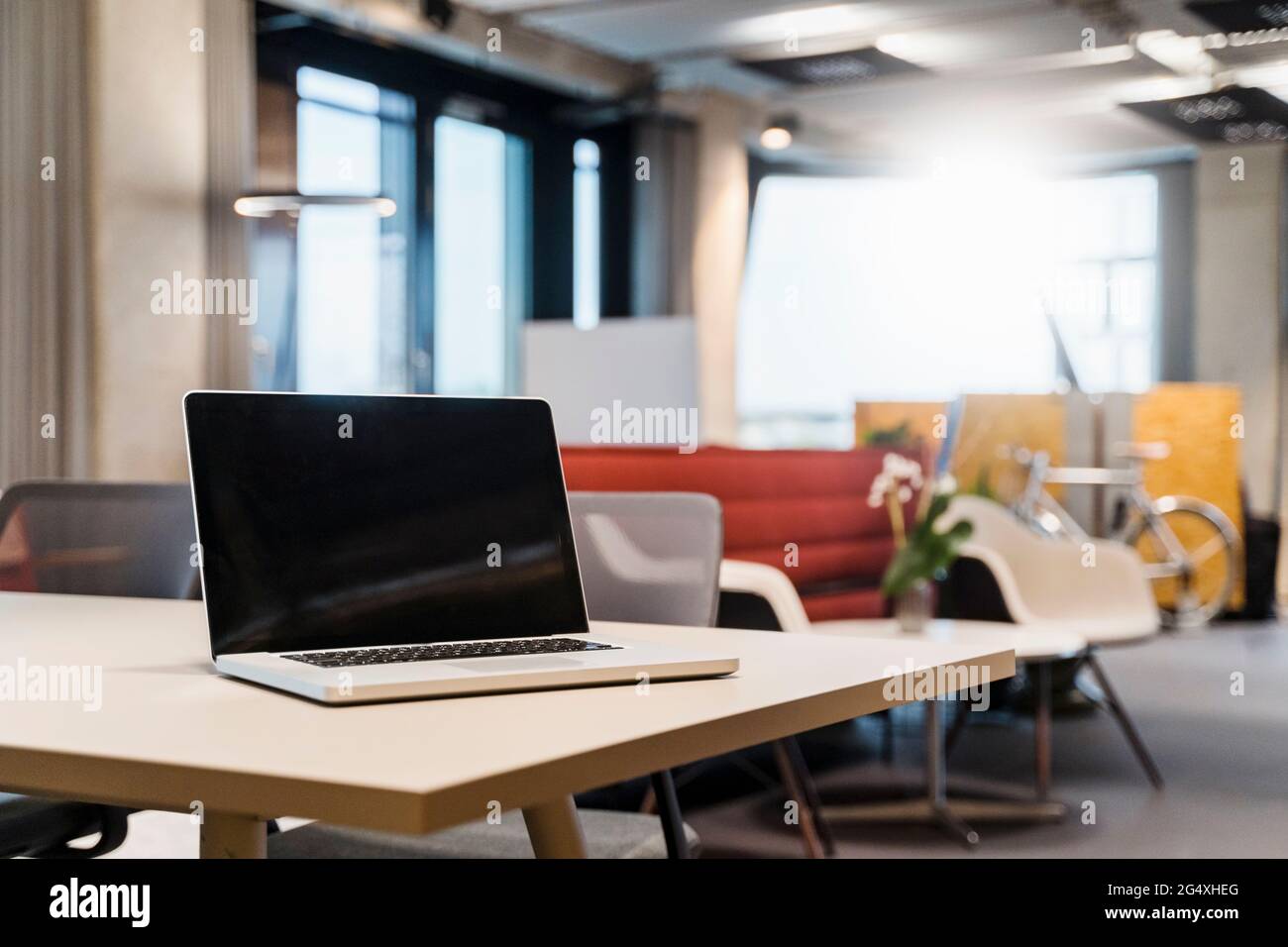 Laptop placed on desk in creative office Stock Photo