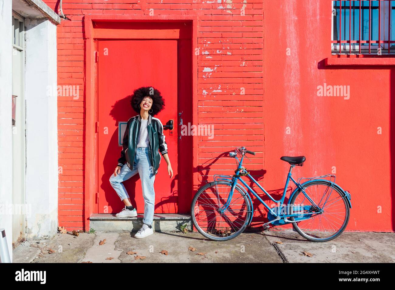 Young afro hair woman smiling while standing at entrance Stock Photo