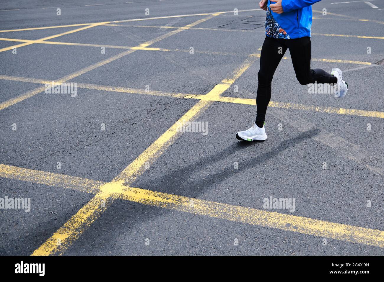 Man running on road in city Stock Photo