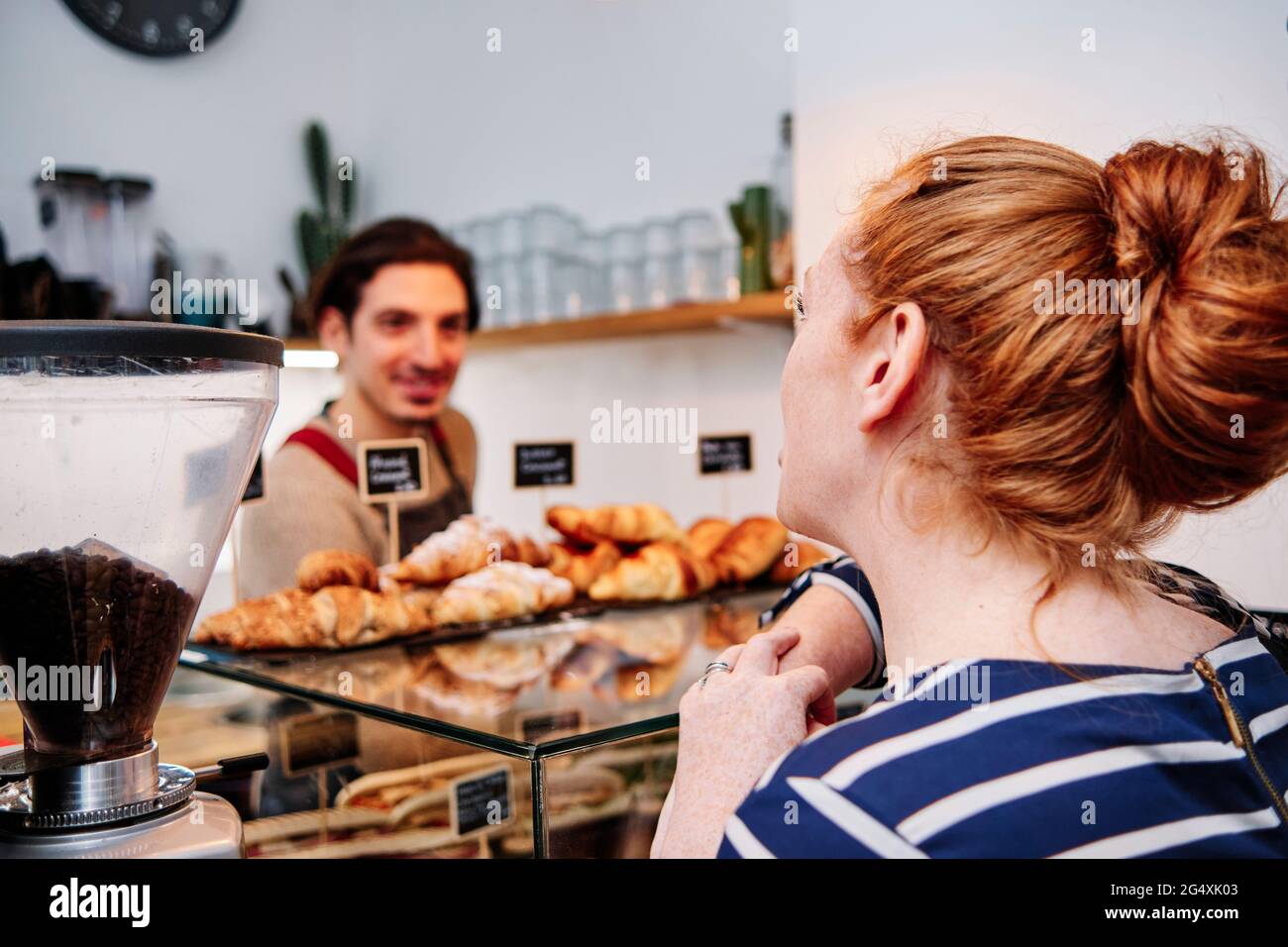 Woman ordering to owner at cafe Stock Photo