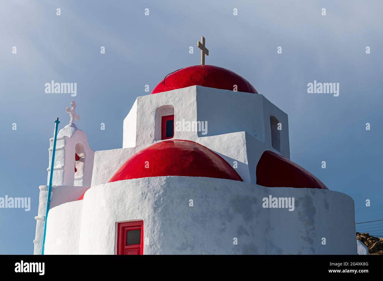 Architectural domes of church with religious cross in Mykonos, Greece Stock Photo