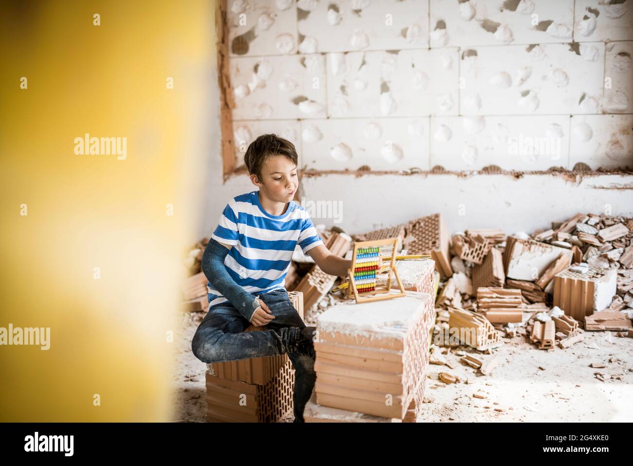 Boy counting bead of abacus toy at house during renovation Stock Photo