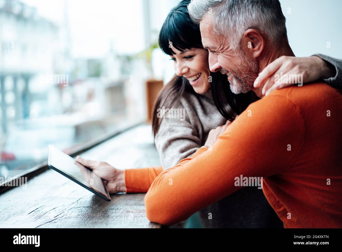 Mature couple using digital tablet in coffee shop Stock Photo