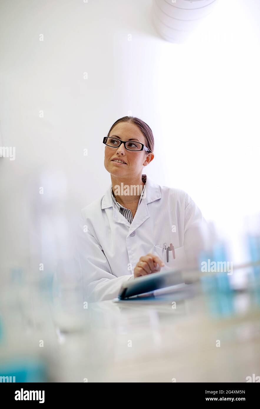 Lab technician looking away while working in laboratory Stock Photo Alamy