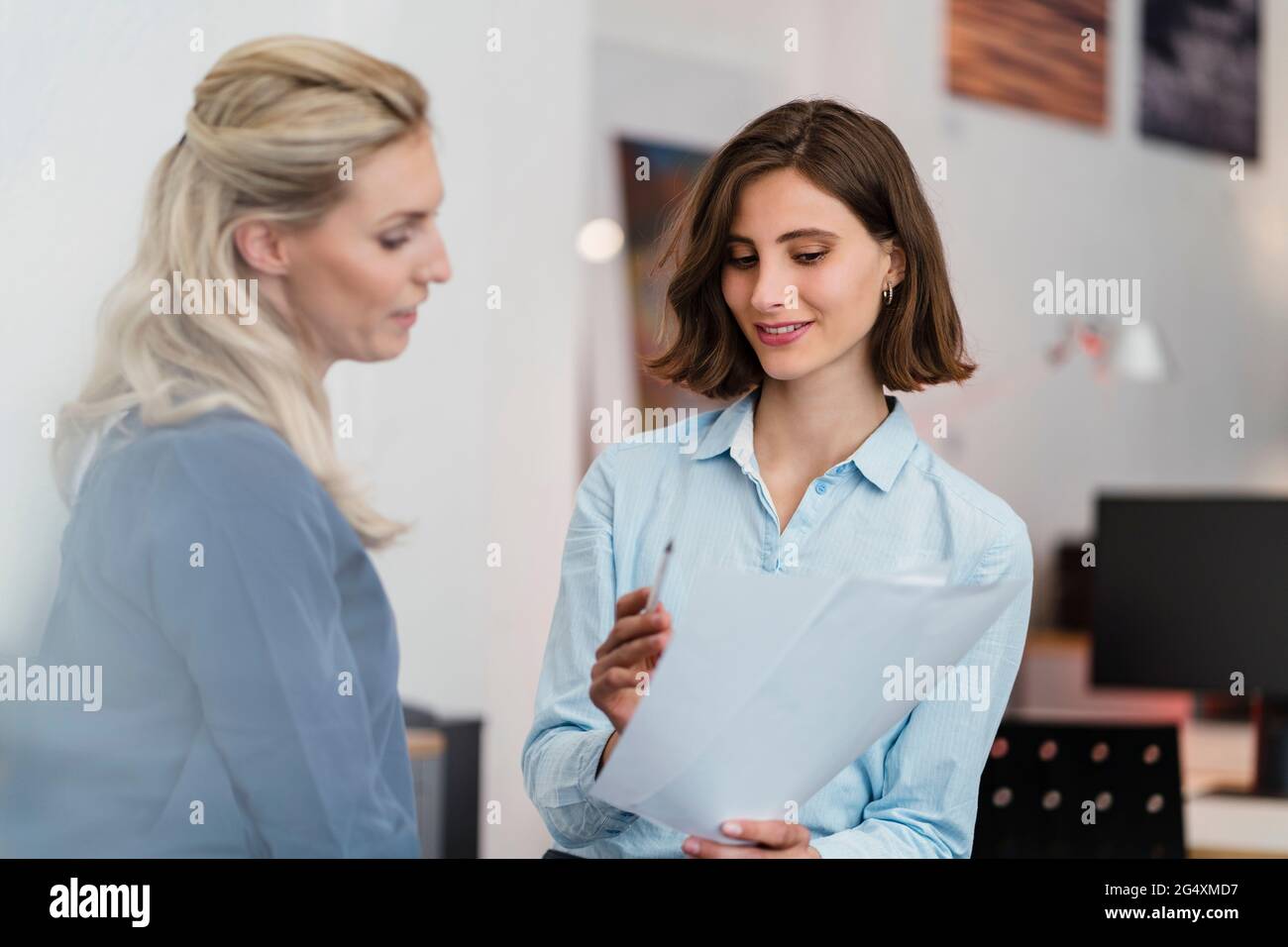 Female entrepreneurs discussing over document in office Stock Photo