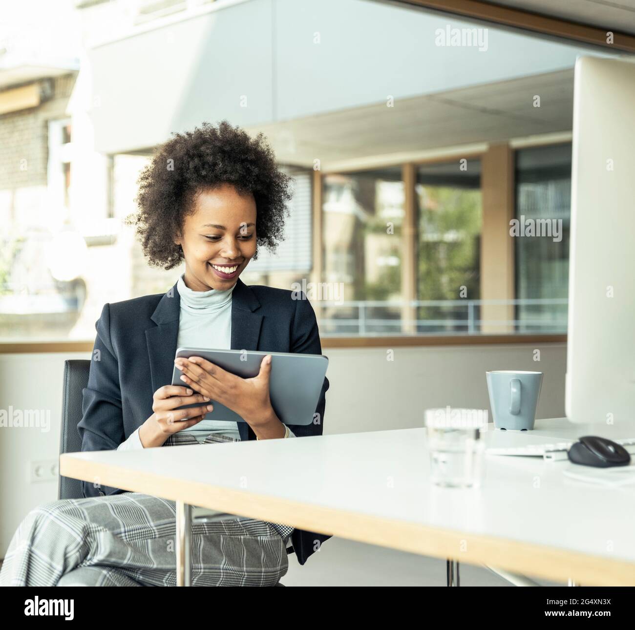 Female entrepreneur using digital tablet at office Stock Photo