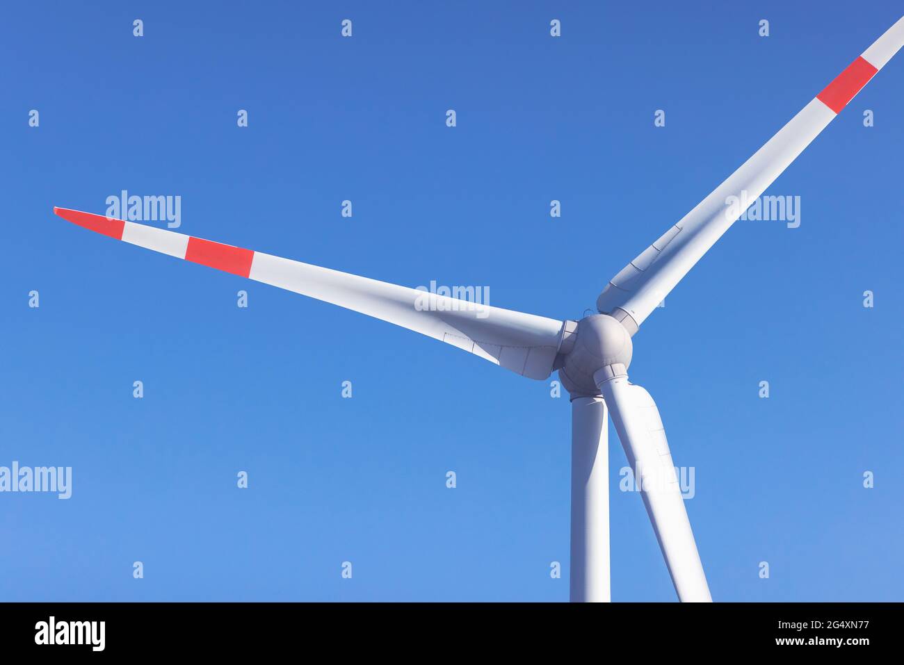 Wind turbine standing against clear blue sky Stock Photo - Alamy
