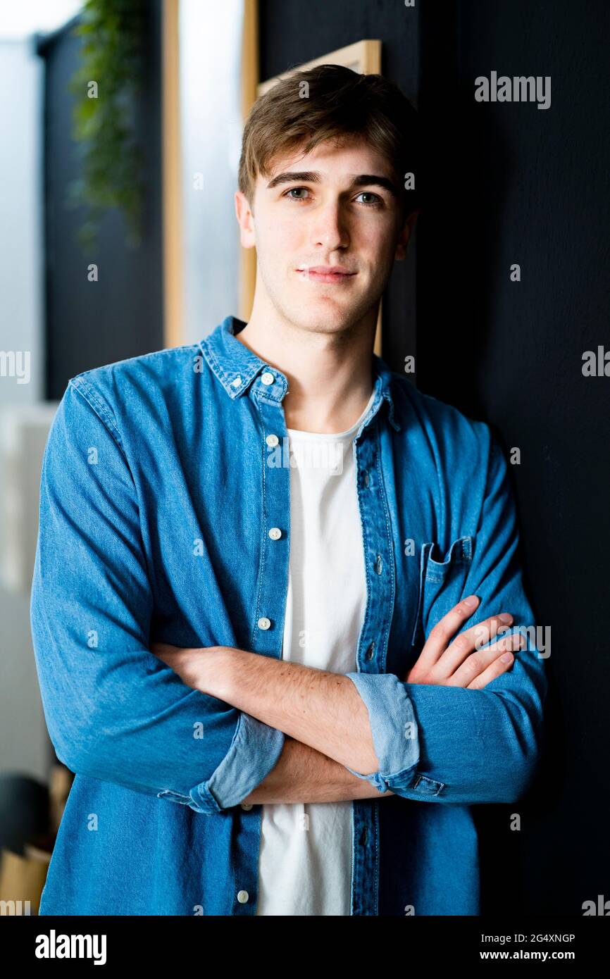 Young businessman with arms crossed standing at warehouse office Stock ...