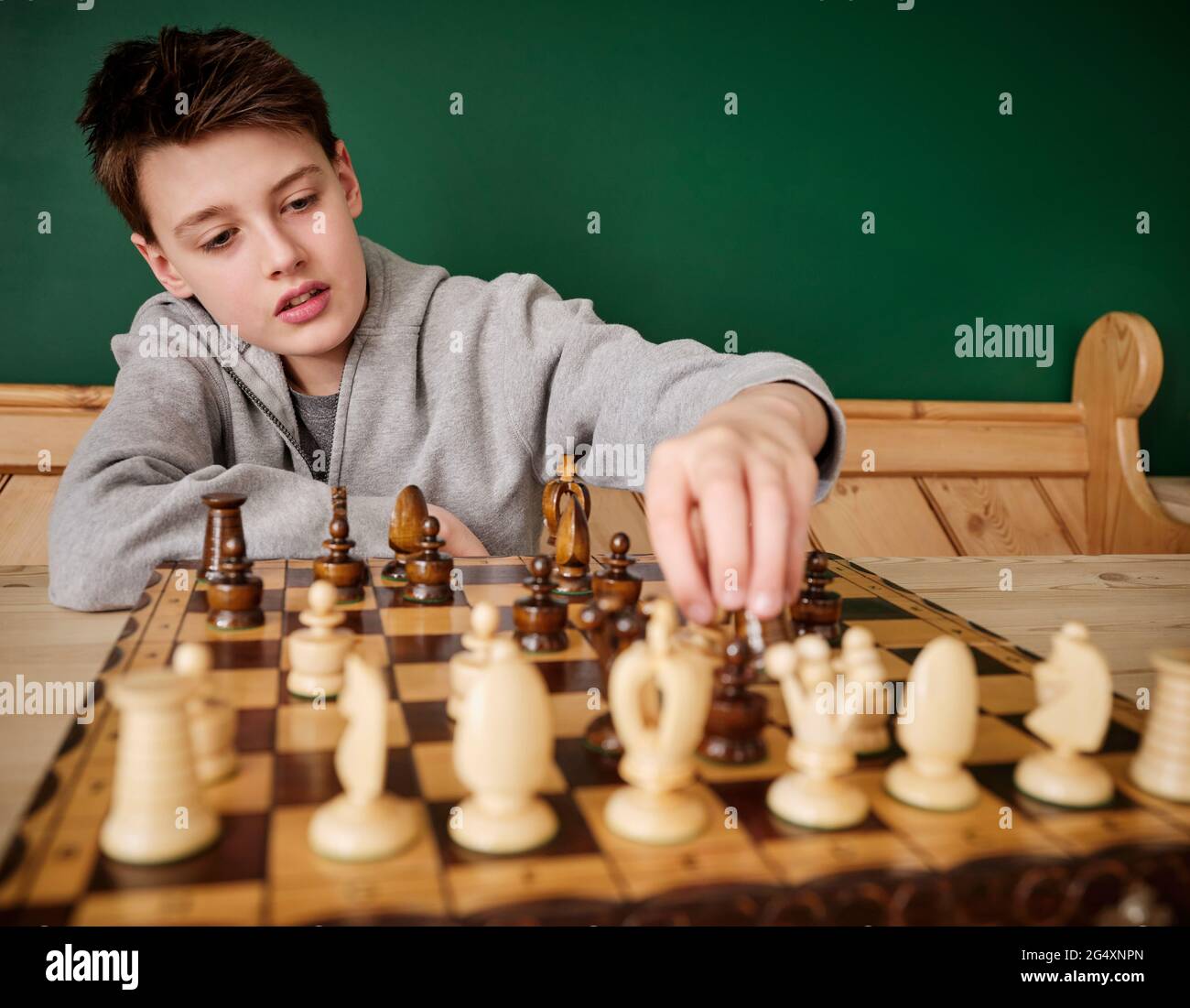 Boy playing chess at home Stock Photo