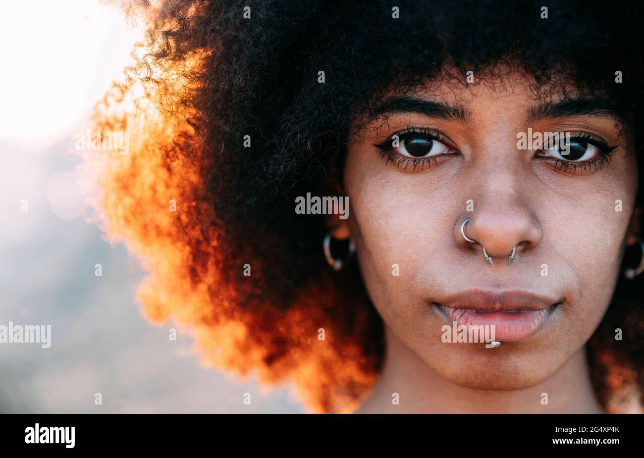 Beautiful woman with pierced nose at beach Stock Photo