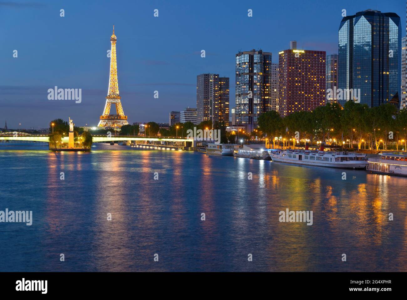 FRANCE, PARIS (75015), THE SEINE, THE QUAI DE GRENELLE BUILDINGS AND THE EIFFEL TOWER AT NIGHT FRANCE, PARIS (75015), THE SEINE, THE QUAI DE GRENELLE BUILDINGS AND THE EIFFEL TOWER AT NIGHT