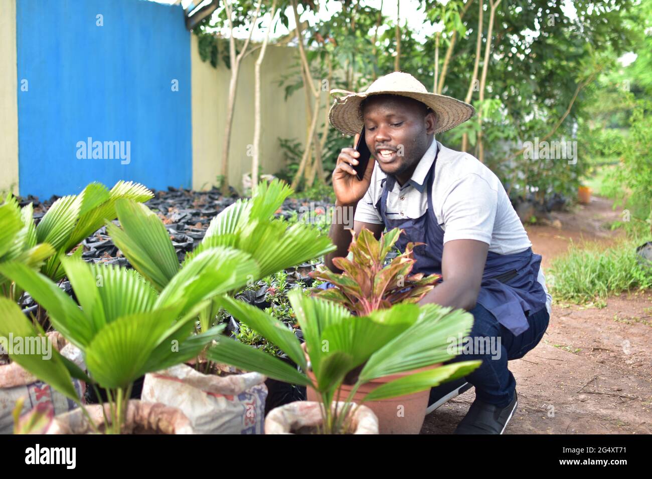 an african florist making receiving a phone call Stock Photo