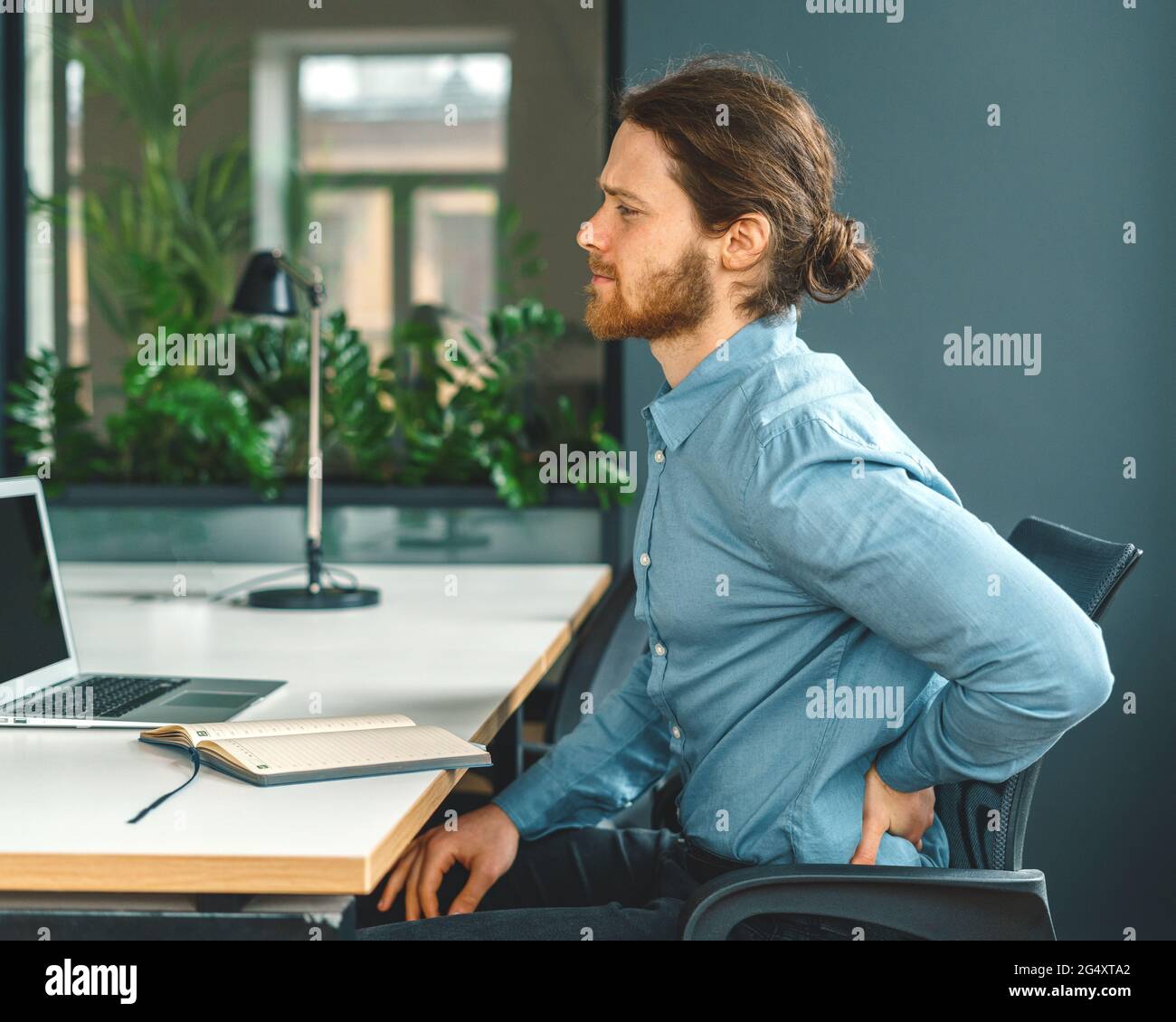 Male office worker suffering from terrible pain in lower back Stock Photo