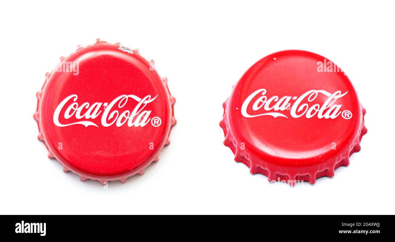 BERLIN - JUNE 23: Used, damaged classic Coca Cola cap isolated on white. Top and side views of cola caps in Berlin, June 23, 2021 in Germany Stock Photo