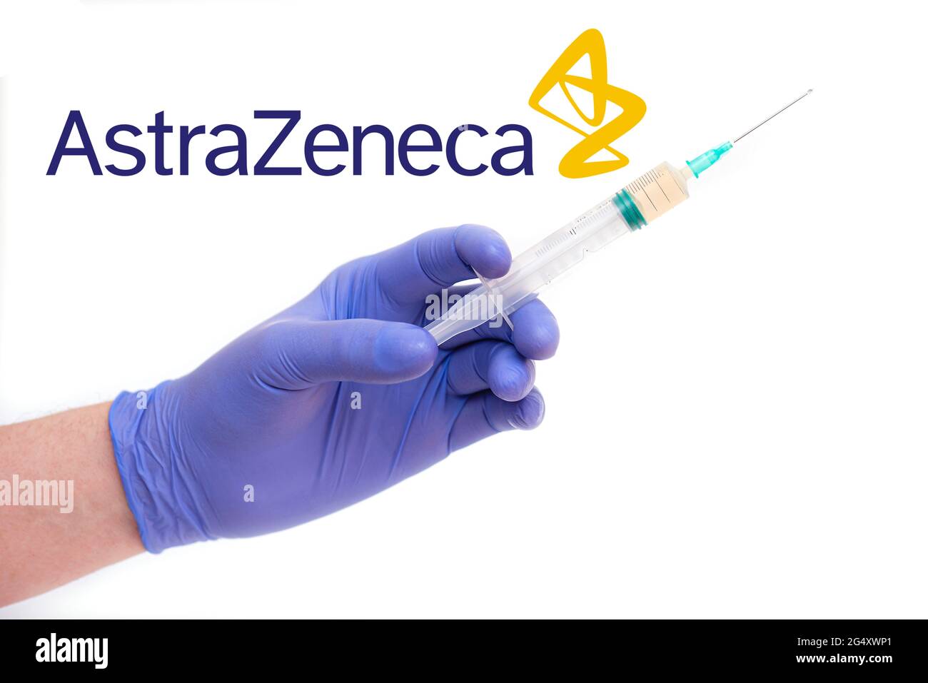 BERLIN - JUNE 23: AstraZeneca logotype and a doctor holding syringe with needle, vaccine isolated on white in Berlin, June 23, 2021 in Germany Stock Photo