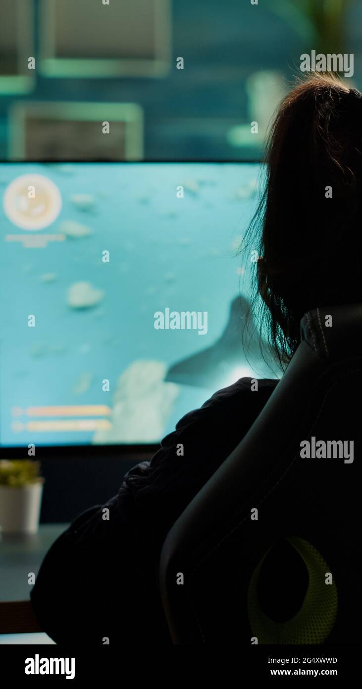 Back shot of pro gamer playing online shooter game on computer using  wireless controller. Competitive player man winning videogame tournament  use professional equipment at home gamming studio Stock Photo - Alamy