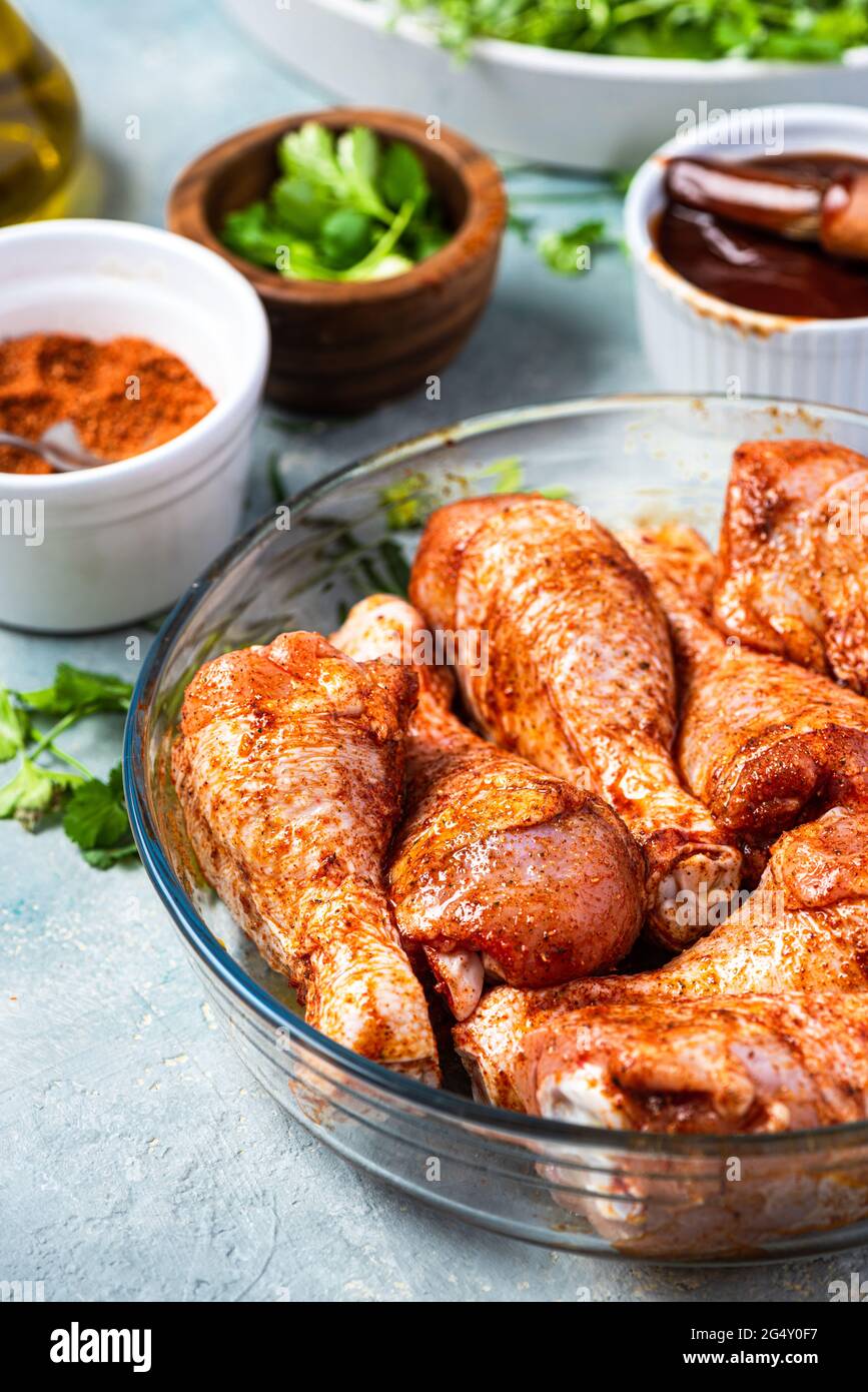 Marinating Raw Chicken Drumsticks in Herbs and Spices Stock Photo Alamy