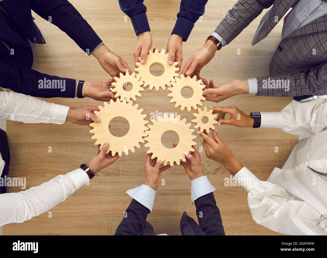 Professional business team connecting cogwheels as metaphor for ...