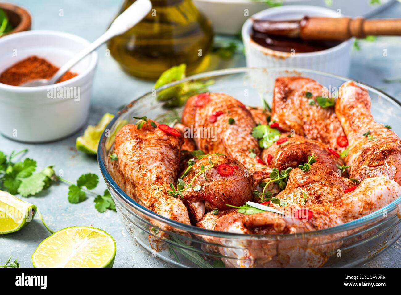 Raw Chicken Drumsticks Legs Marinating in Herbs and Hot Spices for BBQ