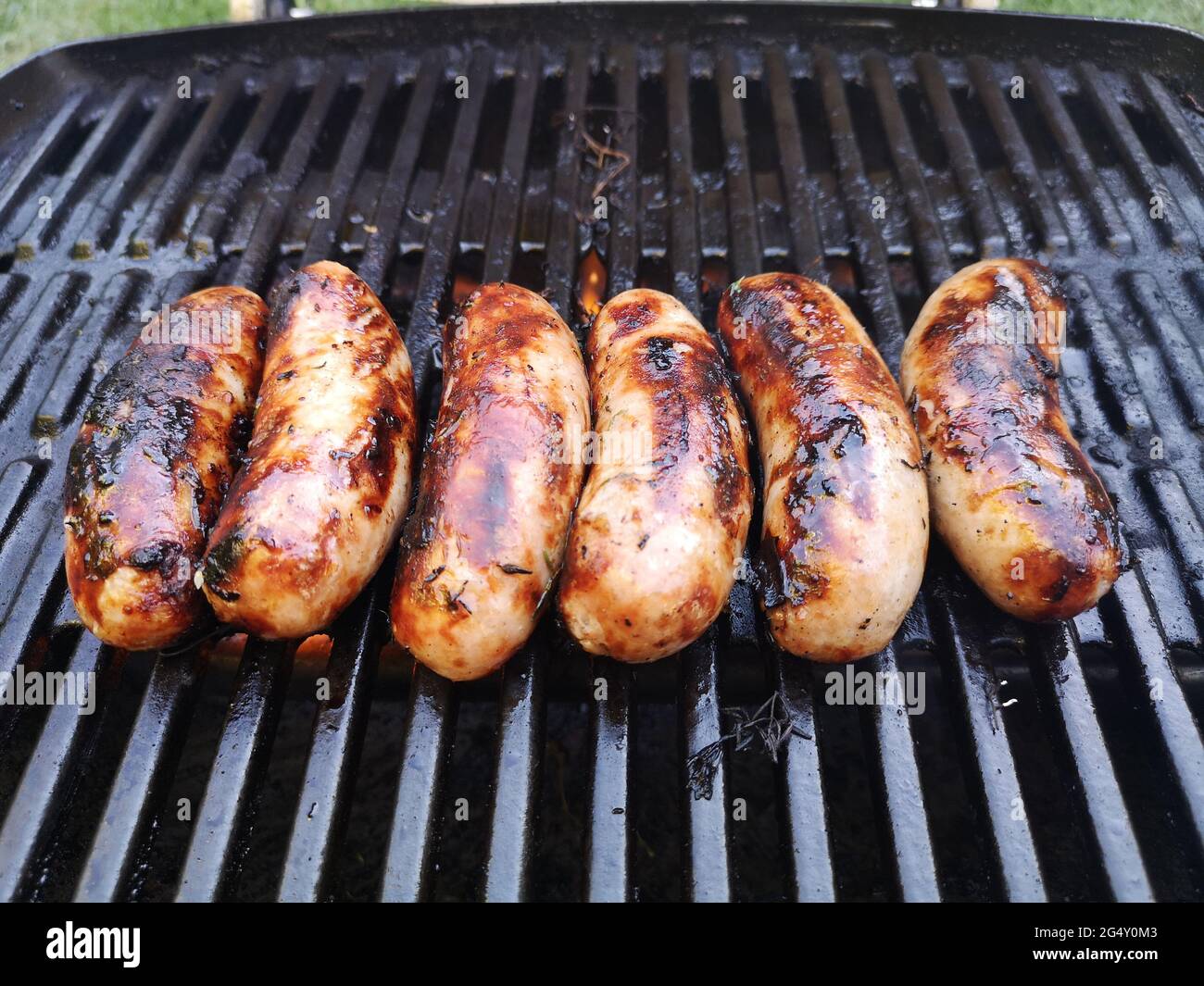Pork Sausages cooking on a gas er Q BBQBritish Pork Sausages cooking