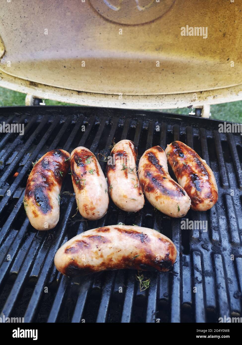 Pork Sausages cooking on a gas Weber Q BBQBritish Pork Sausages cooking a gas Q BBQ Photo - Alamy