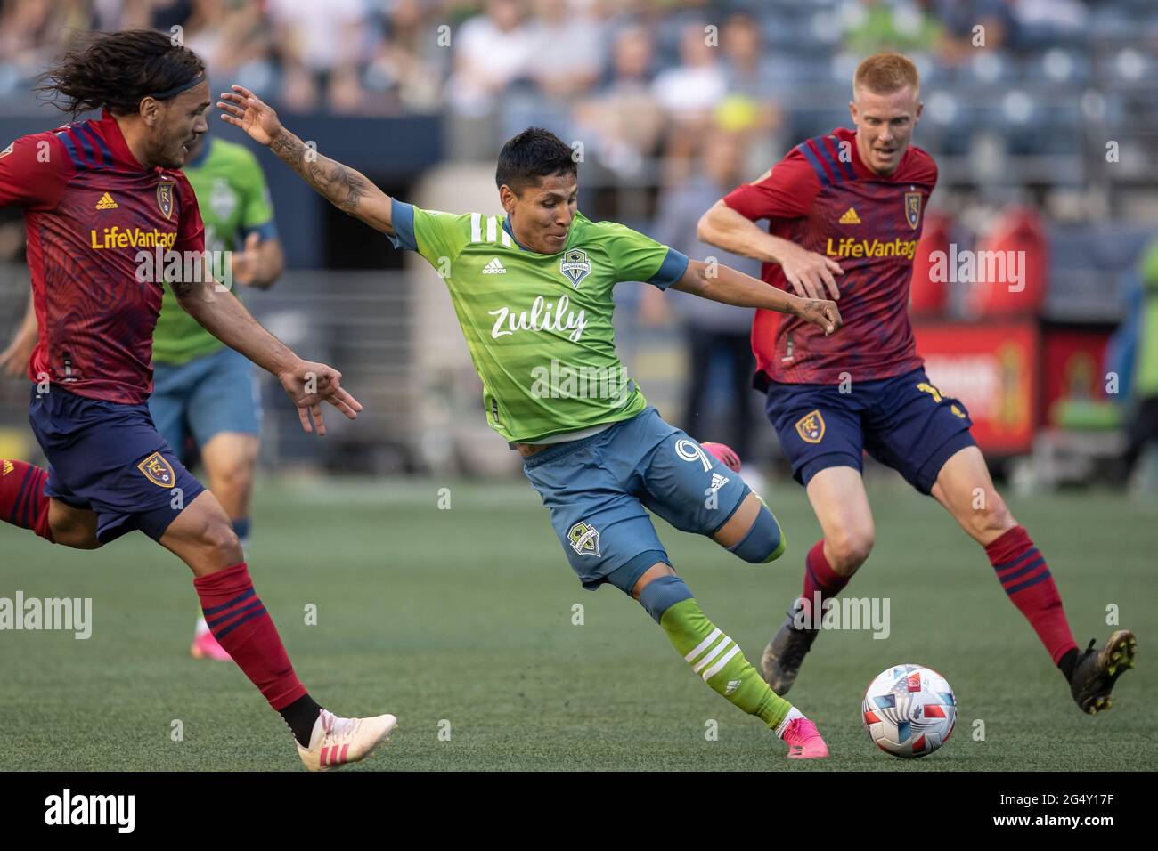 Seattle Sounders forward Raul Ruidiaz (9) passes the ball against Real Salt Lake defender Marcelo Silva (30) and defender Justen Glad (15) during the Stock Photo