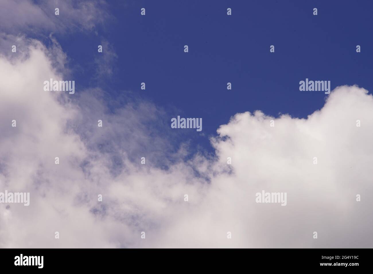 background lovely blue sky with white fluffy clouds Stock Photo - Alamy