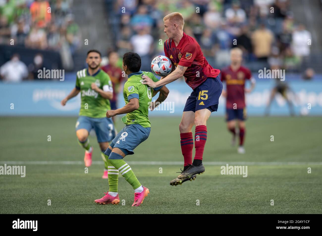 Real Salt Lake defender Justen Glad (15) and Seattle Sounders forward Raul Ruidiaz (9) battle for a header during the first half of an MLS match at Lu Stock Photo
