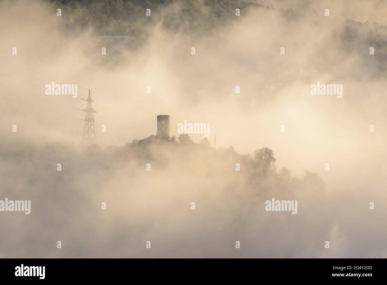 Oliana Castle among the fog in a winter sunrise (Alt Urgell, Lleida, Catalonia, Spain, Pyrenees) ESP: Castillo de Oliana entre la niebla al amanecer Stock Photo