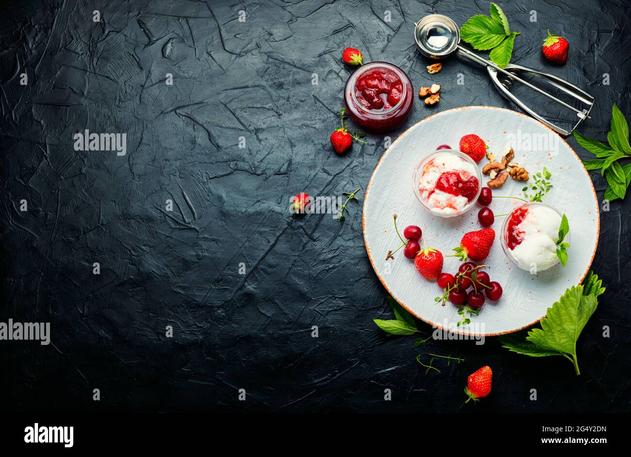 Summer dessert, ice cream with strawberries and cherries.Ice cream with berry jam.Copy space Stock Photo