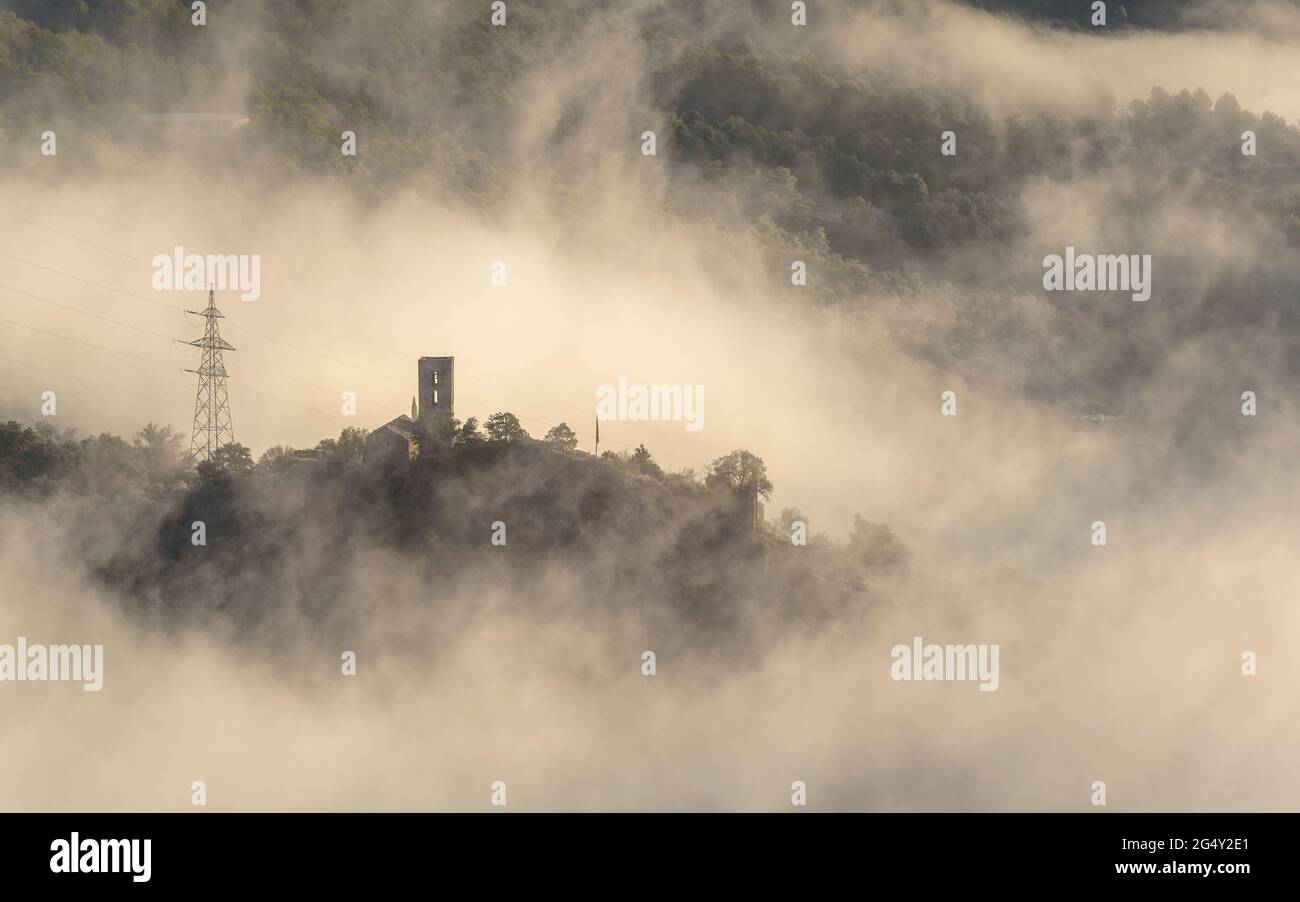 Oliana Castle among the fog in a winter sunrise (Alt Urgell, Lleida, Catalonia, Spain, Pyrenees) ESP: Castillo de Oliana entre la niebla al amanecer Stock Photo