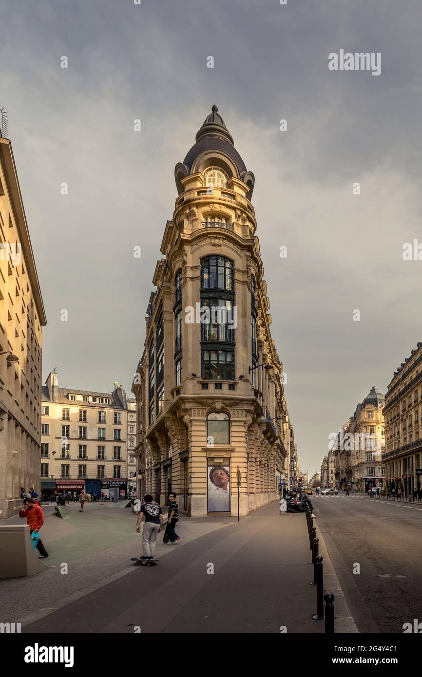 Paris, France - February 25, 2021: Typical Haussmann buildings and street near stock exchange market monument in paris Stock Photo