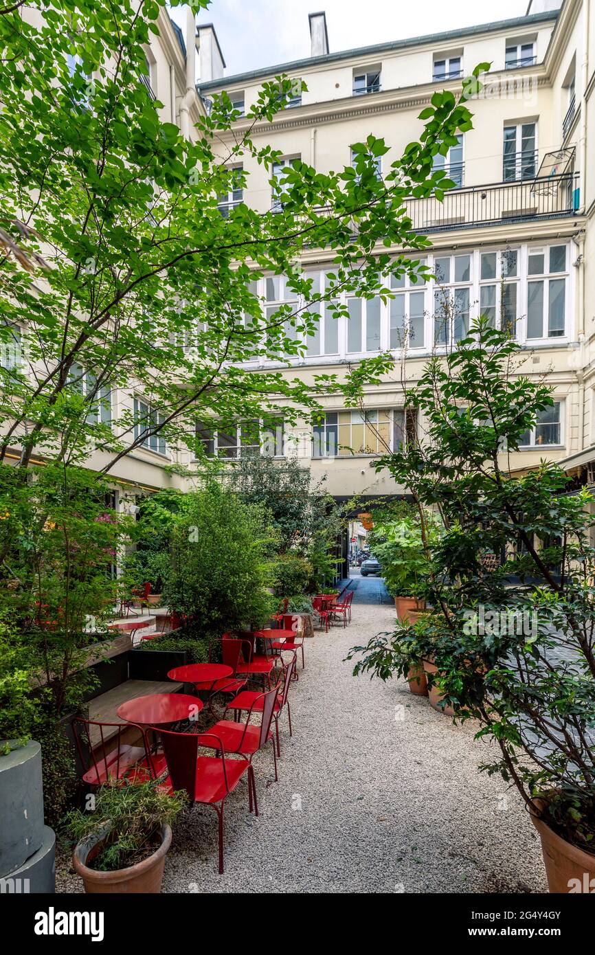 Paris, France - April 15, 2021: Restaurant brasserie is closed due to epidemic of coronavirus COVID19 in Paris. Empty bar, chairs raised, no guests. S Stock Photo