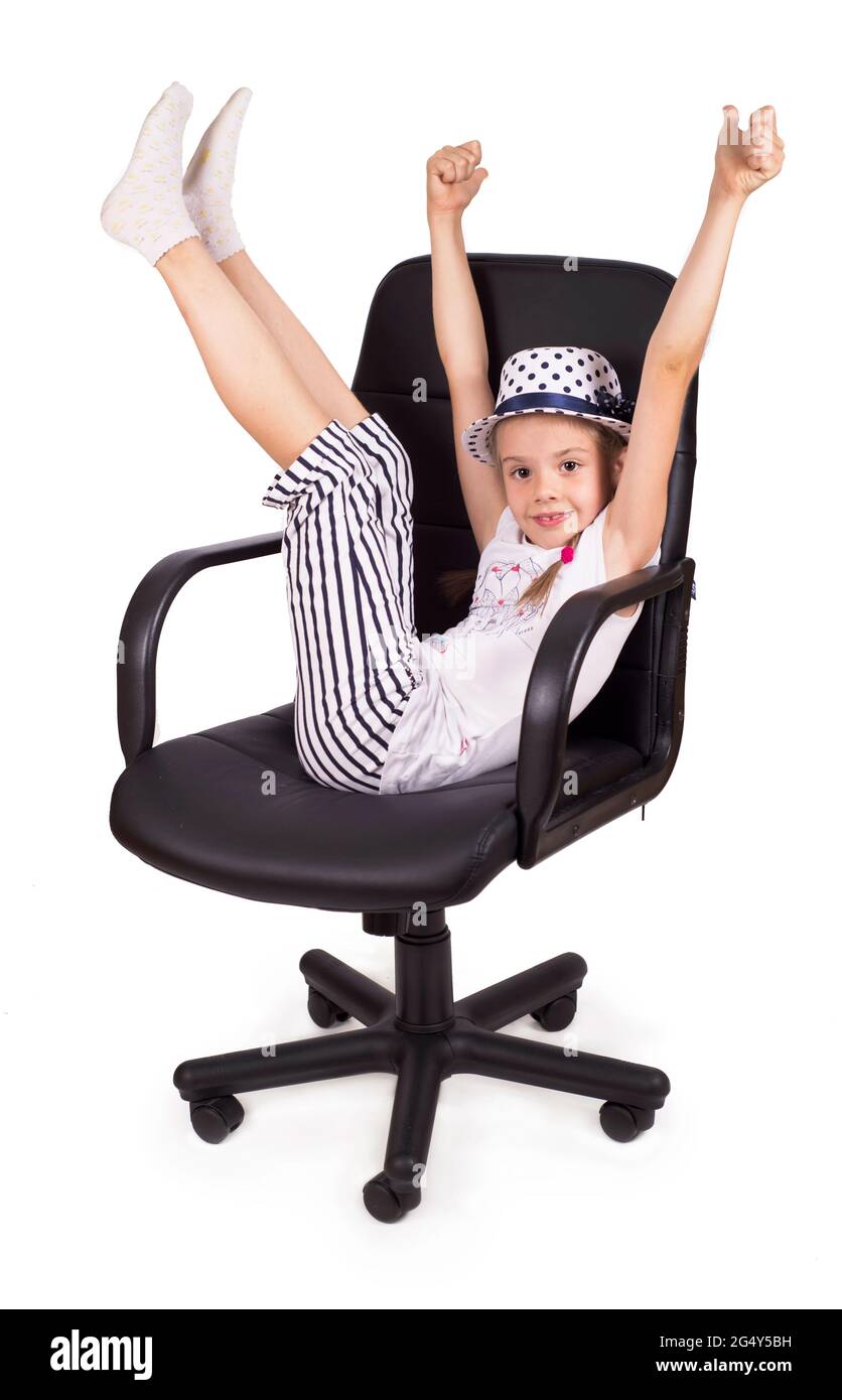 Office chair office chair office chair and little cheerful girl lifted her legs up isolated on white background. Modern adjustable chair from black Stock Photo