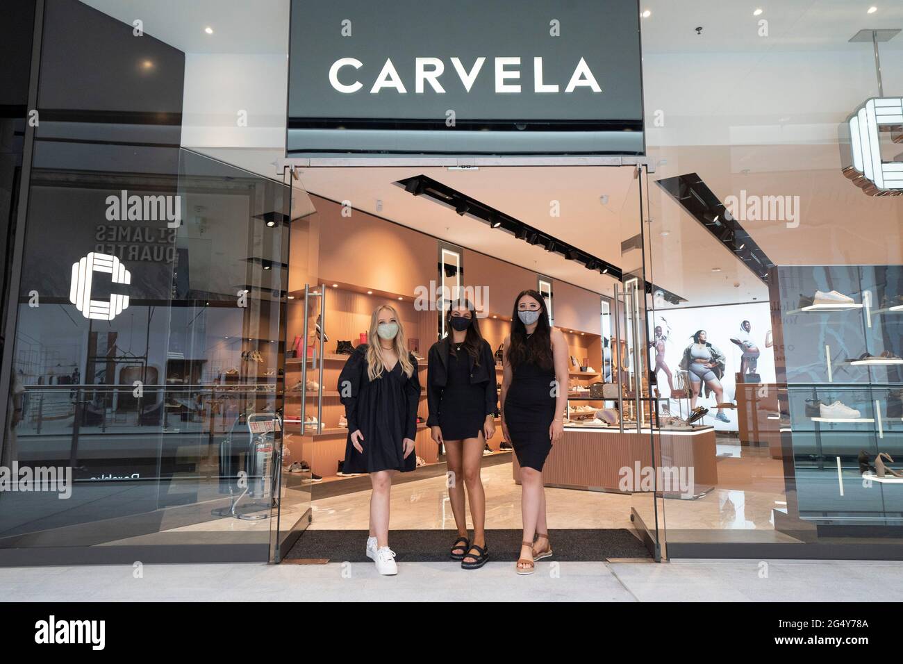 Edinburgh, Scotland, UK. 24 June 2021. First images of the new St James Quarter which opened this morning in Edinburgh. The large retail and residential complex replaced the St James Centre which occupied the site for many years. Pic; Staff at Carvela pose after opening doors for the first time. Iain Masterton/Alamy Live News Stock Photo