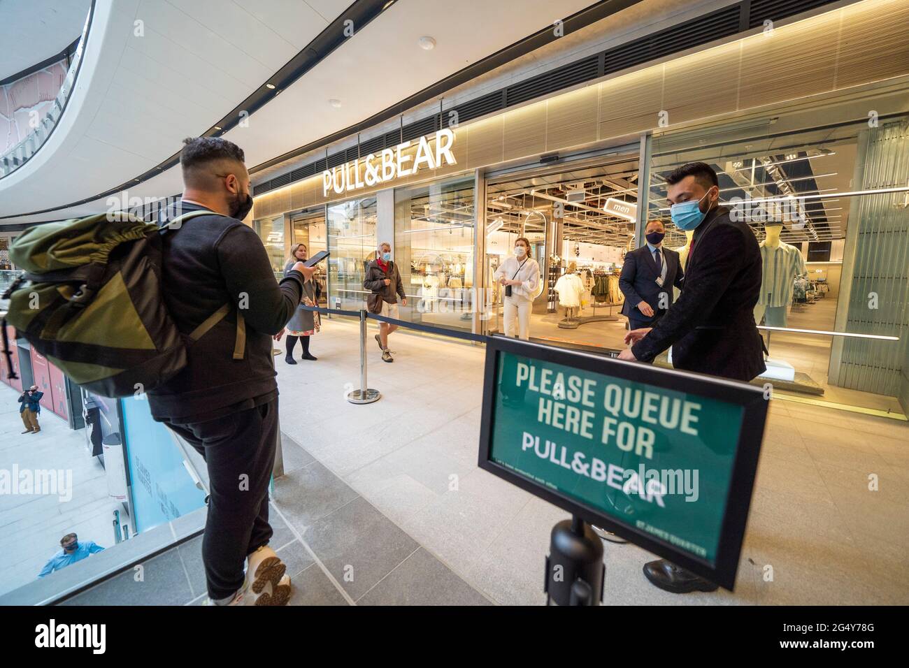 Edinburgh, Scotland, UK. 24 June 2021. First images of the new St James Quarter which opened this morning in Edinburgh. The large retail and residential complex replaced the St James Centre which occupied the site for many years.  Queue outside Pull & Bear shop. Iain Masterton/Alamy Live News Stock Photo